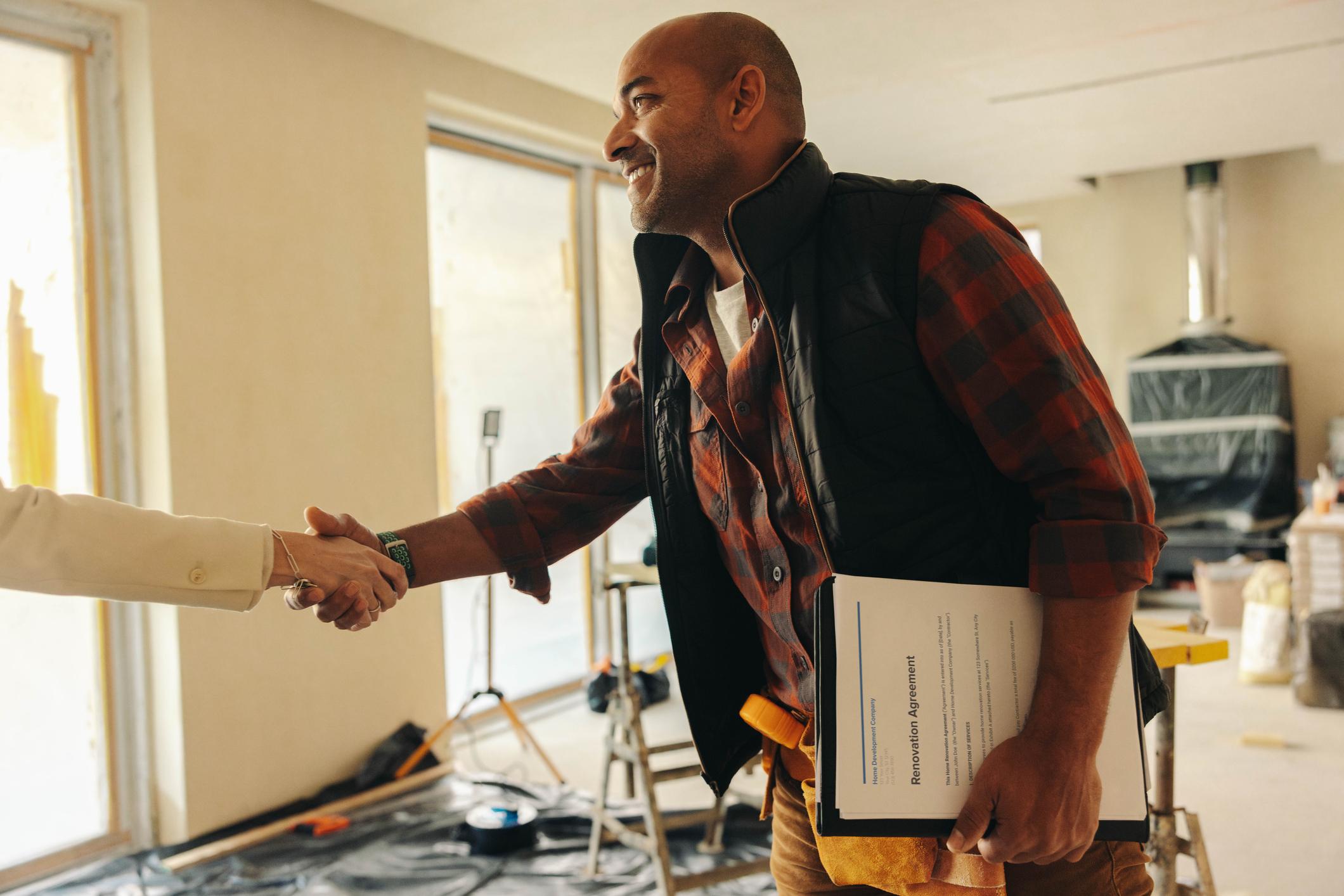 Contractor shaking hands with client who is off screen
