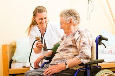 Nurse checking blood pressure