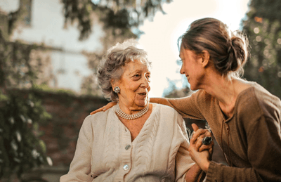 Happy surprised senior mother in garden