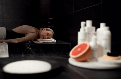 A Woman Prone Position Inside a Spa Room