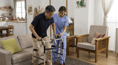 A man being assisted using a walker