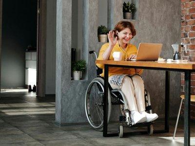 Woman in wheelchair using laptop
