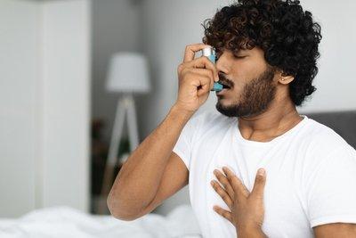 Man using an inhaler