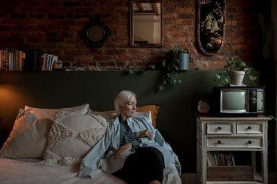 Elderly woman sitting in bed.