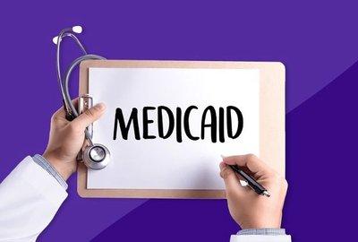 Medicaid written on a doctor's clipboard