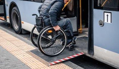 Wheelchair user entering bus